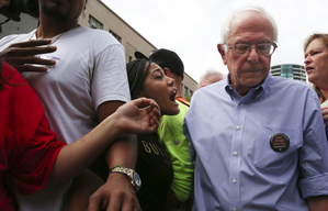 Democratic presidential candidate Sen. Bernie Sanders, I-Vermont, is confronted on the Westlake Park stage by