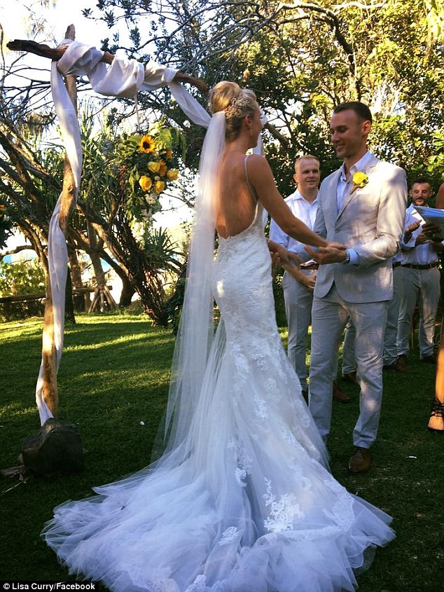 Beach ceremony: The bride stunned in a backless dress with a fitted bodice and lace overlay