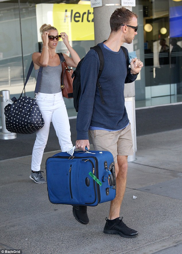 Plane chic: For the flight, Morgan donned a casual and comfortable outfit including a grey tank top tucked into white skinny jeans, which showed off her trim figure. Meanwhile her new hubby wore shorts and a light jumper