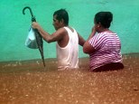Downpour: A couple wades in a flooded street in Acapulco following tropical storm Manuel which landed on the Pacifiic coast of Mexico on September 15