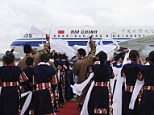Local Tibetans wave hada, or traditional silk scarves, as they greet the first group of passengers who landed at Daocheng Yading Airport