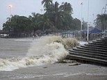 Deluge: Waves crash onto a beach as the Pacific resort of Acapulco is hit by Tropical Storm Manuel