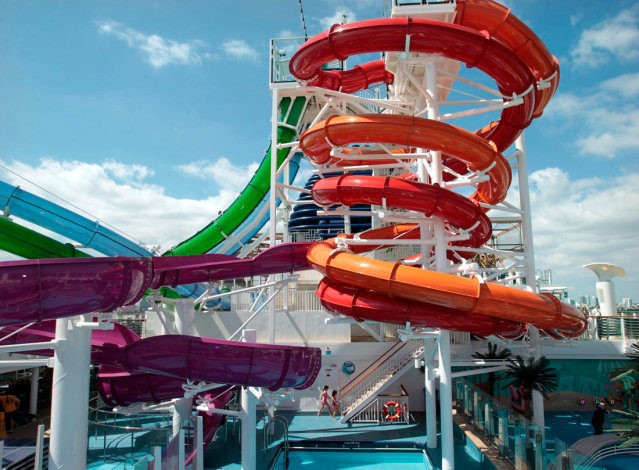 Two girls climb to the top of a cluster of water slides on board the Norwegian Getaway, the newest ship from Norwegian Cruise Lines, on March 1 in Miami. (Marsha Halper/Miami Herald/MCT)